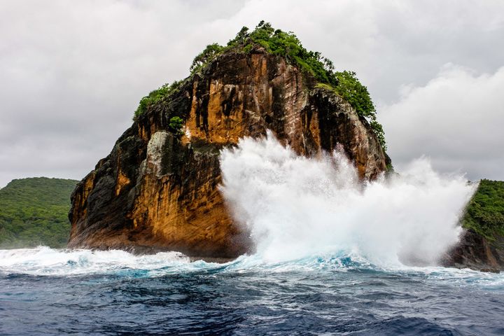 Waves crash into rock formations en route to Ofu Island. 