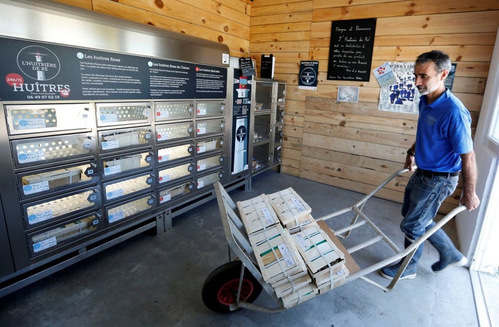 Tony Berthelot arrives with oysters at l'huitriere de Re, where the automatic oyster vending machine is set, in France on Aug. 2. 