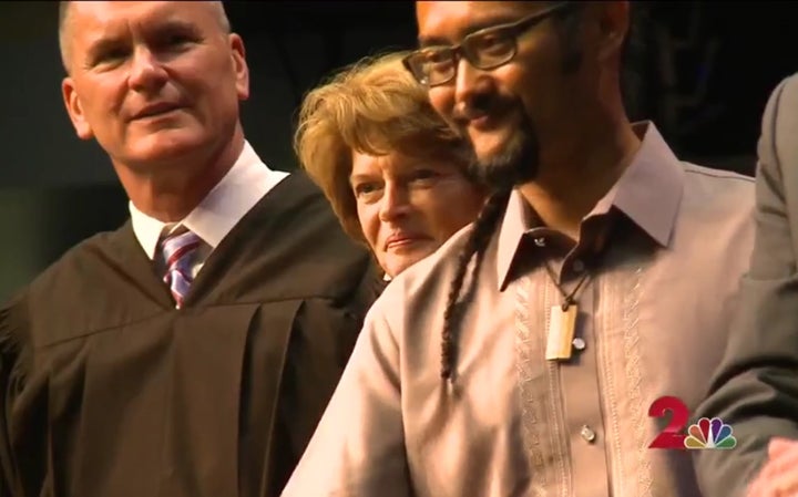 <p>Federal District Court Judge Tim Burgess, U.S. Senator Lisa Murkowski, and E.J.R. David congratulating 136 new U.S. Citizens. Screen shot of KTUU Alaska/NBC coverage of a Naturalization Ceremony in Anchorage.</p>