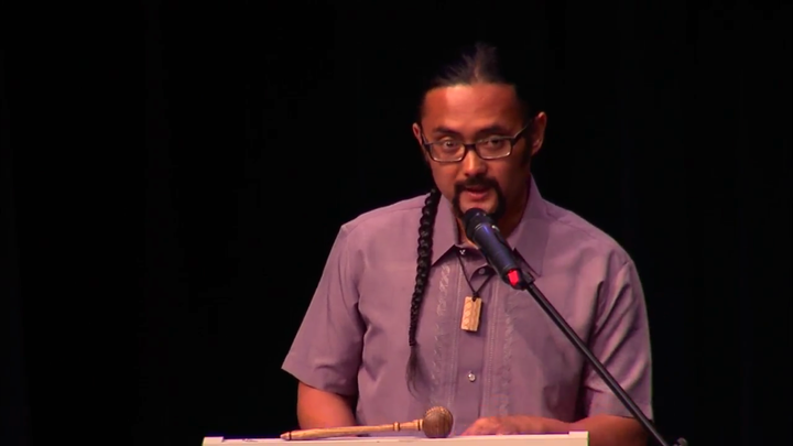 <p>E.J.R. David speaking to 136 new U.S. Citizens and their families. Screen shot of YourAlaskaLink.com’s coverage of a Naturalization ceremony in Anchorage.</p>
