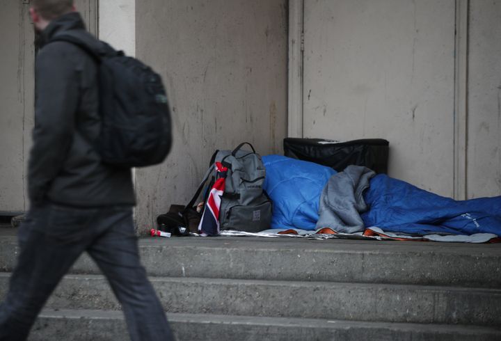 A homeless person sleeping rough in a doorway in London