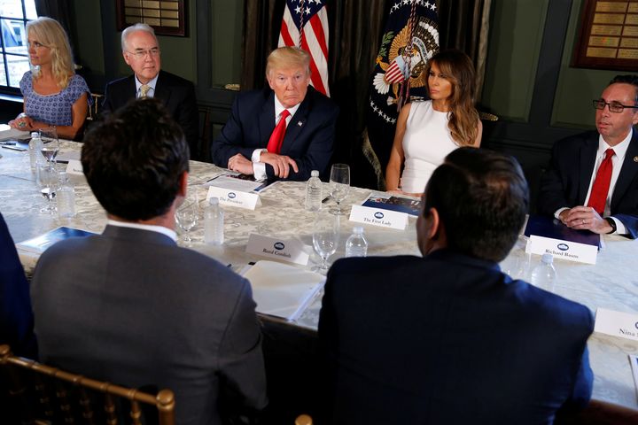 Donald Trump (C) with first lady Melania Trump (R) meets with Secretary of Health and Human Services (HHS) Tom Price (L) to discuss opioid addiction during a briefing at Trump's golf estate in Bedminster, New Jersey