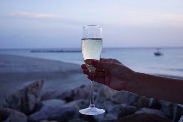 Enjoying a glass of prosecco while watching the sunset at Four Seasons Resort Nevis, Mango Restaurant