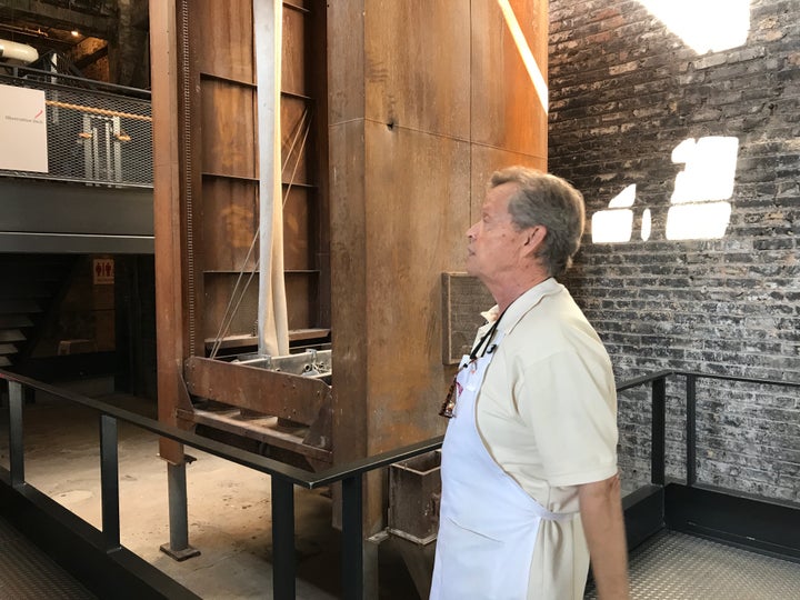 <p><em>Frank Keller shows off a century old device for sucking flour out of the factory air.</em></p>