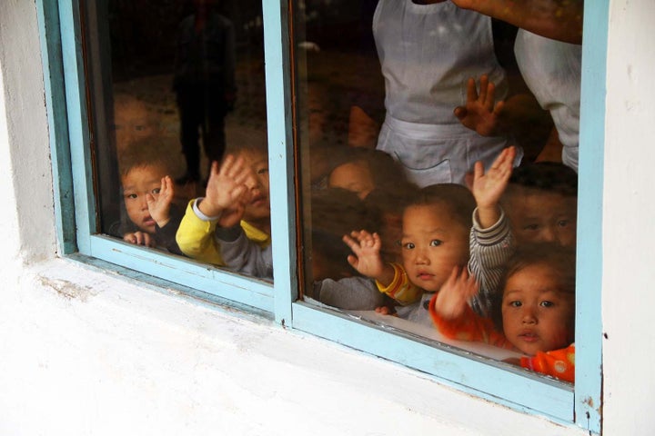 Children at Samchon Nursery School wave from a window. Children here receive soy, oil and cereal milk blend. The food is donated by the international community as North Korea struggles to produce food for its own people. Seven out of every 10 of its citizens live in hunger, with child malnutrition a huge crisis. The country needs to focus on food production, not nuke production. 