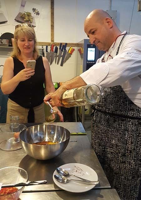 <p><em>Chef Marco Giachello measuring rum during the Turin Epicurean Capital 2017 cooking class (courtesy Hannau)</em></p>