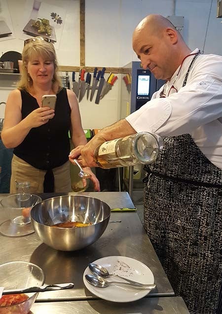 Chef Marco Giachello measuring rum during the Turin Epicurean Capital 2017 cooking class (courtesy Hannau)