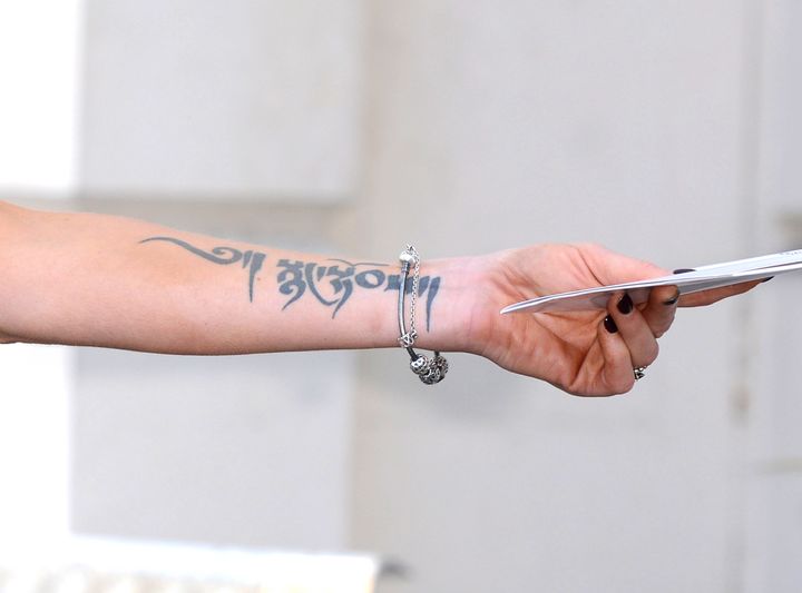 Sarah has several tattoos, including this Tibetan writing