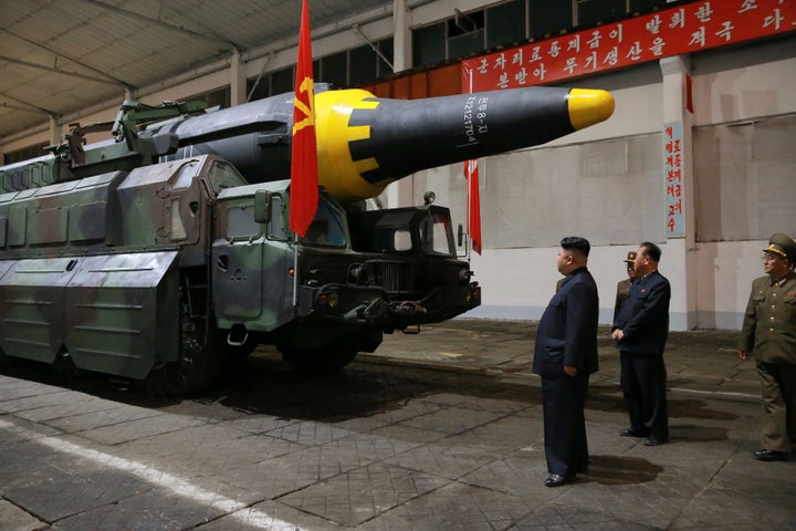 A North Korean state-issued image of leaders Kim Jong Un inspecting a rocket.