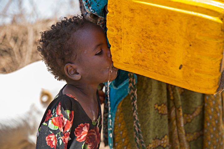 A young girl in Somaliland — a semi-autonomous region in Somalia — drinks water trucked in by Concern Worldwide. Photo: Kieran McConville