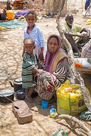 A displaced family rests under the shade of a tree just outside of Mogadishu, Somalia. Photo: Kieran McConville