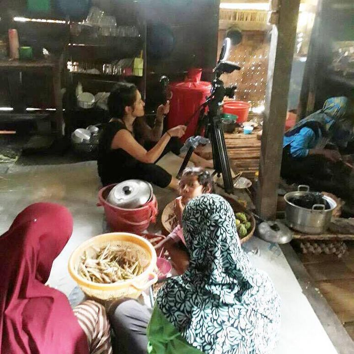 Filmmaker, Lisa Russell, filmming Mrs. Rohani as she prepares dinner with her daughters and nieces. South Sulawesi, Indonesia.