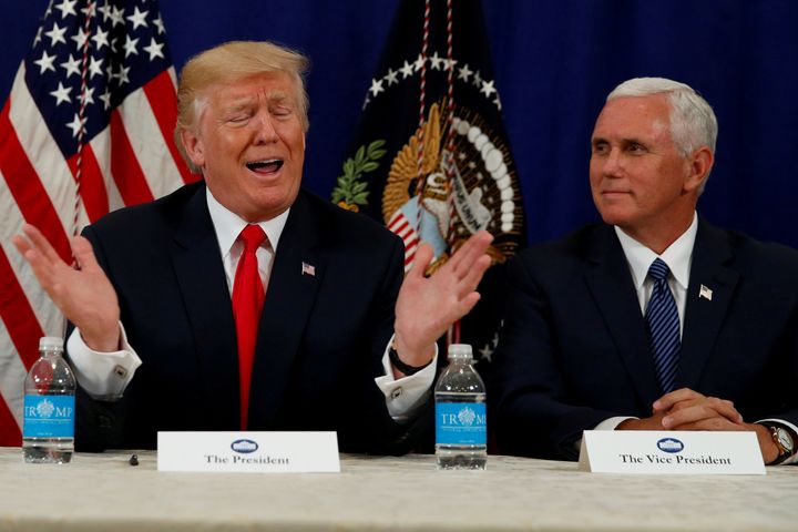 Trump, flanked by Vice President Mike Pence (R), speaks to reporters after a security briefing at his golf estate in Bedminster, New Jersey U.S. August 10.
