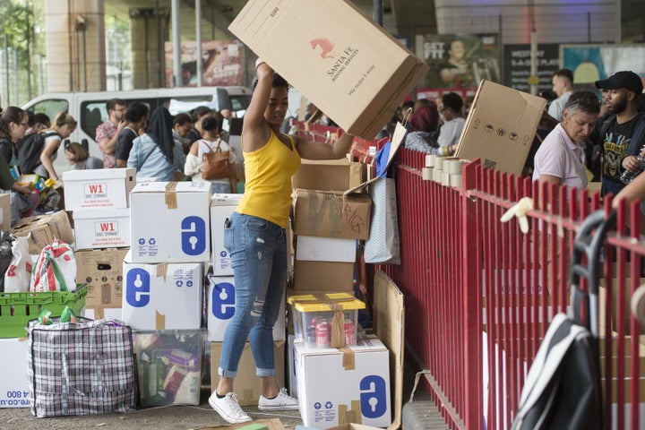 Volunteers organising boxes of donations following near Grenfell Tower in west London during the immediate aftermath of the fire