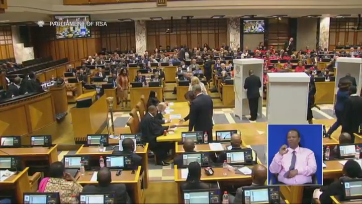 In alphabetical order, parliamentarians pick up ballots and go to booths to mark secret ballots in the August 8 no confidence