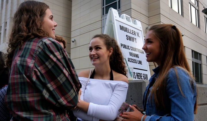 Grace Jarecke, 16, left, Lucy Peterson, 17, and Dani Kuta, 17, right, all from Denver, wait in line to attend the civil case for Taylor Swift vs David Mueller at the Alfred A. Arraj Courthouse on August 8, 2017 in Denver, Colorado.