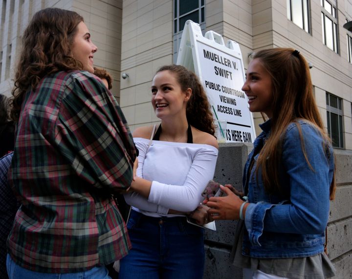 Grace Jarecke, 16, left, Lucy Peterson, 17, and Dani Kuta, 17, right, all from Denver, wait in line to attend the civil case for Taylor Swift vs David Mueller at the Alfred A. Arraj Courthouse on August 8, 2017 in Denver, Colorado. 