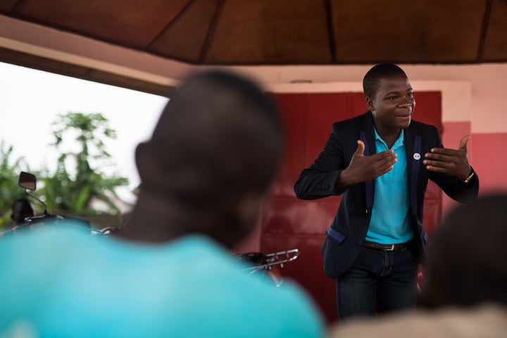 Romaric Ouitona, president of Youth Ambassadors in Benin, speaks to his peers at a youth center that offers family planning services and education in Dangbo, Benin. 