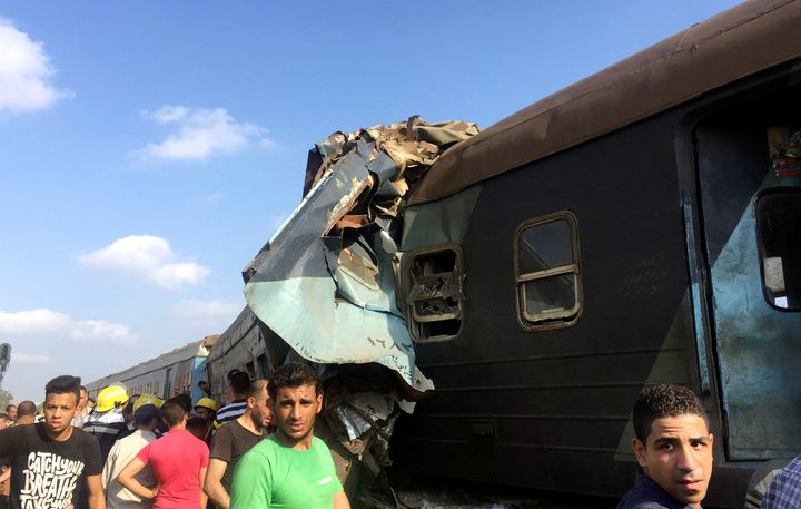 Egyptians look at the crash of two trains that collided near the Khorshid station in Egypt's coastal city of Alexandria, Egypt on August 11.
