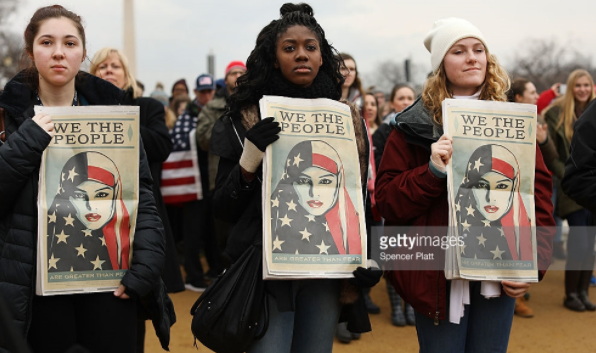 Protesters watch the inauguration of President Trump.