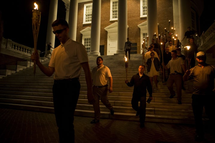 A white woman (right) walks down the steps with a group of neo-Nazis at the University of Virginia on Aug. 11.