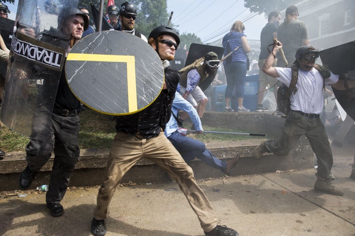 White supremacists rush forward with shields and sticks during clashes with counter-protesters at Emancipation Park in Charlo