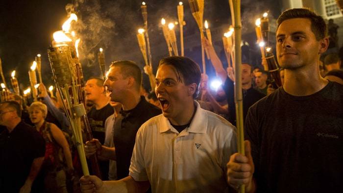 Neo Nazis, Alt-Right, and White Supremacists encircle and chant at counter protestors at the base of a statue of Thomas Jeffe