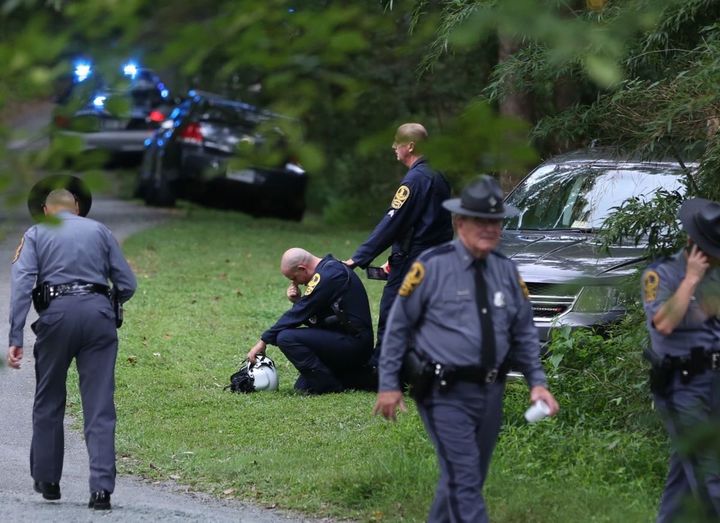 A Virginia law enforcement officer cries near the site of a state police helicopter crash, which killed two state troopers.