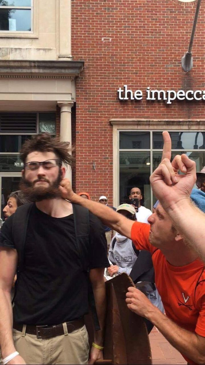 A white supremacist protester is punched in the face by a counter protester after giving a Nazi salute.