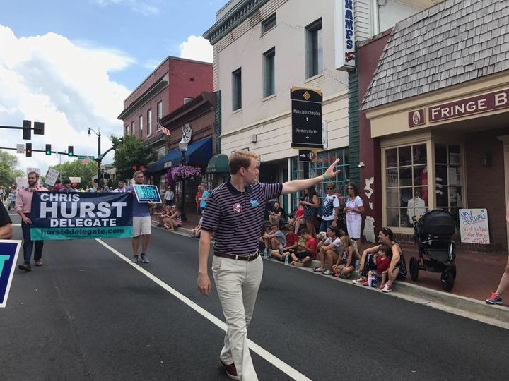 Chris Hurst, Democratic candidate for Virginia's House of Delegates, waves to the crowd at the Independence Day parade in Blacksburg, Virginia.