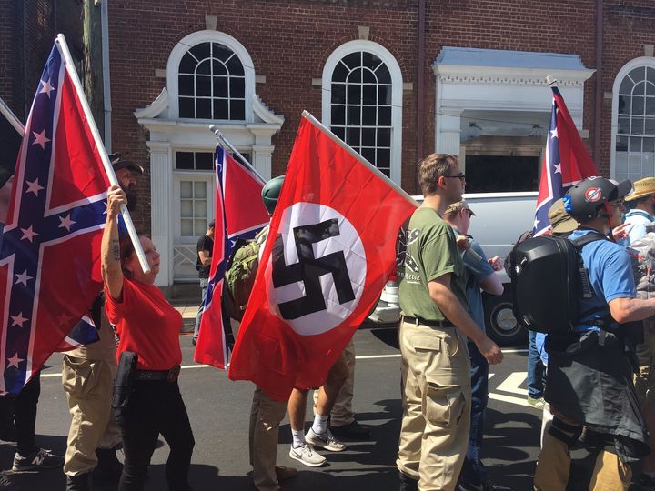 "Unite the Right" protestors gather in Charlottesville carrying flags emblazoned with swastikas.