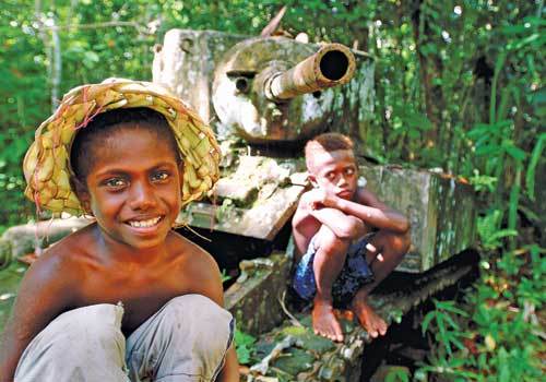 <p>Solomon Islands kids sitting on WWII tank</p>