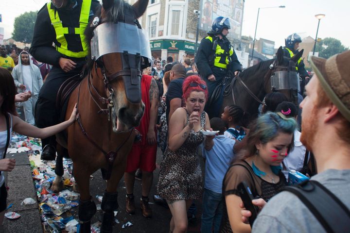Riot police move through carnival crowds on west London's Portobello Road
