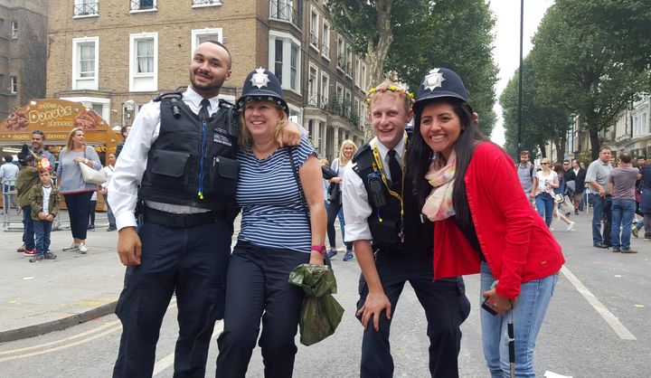 Revellers pose with police for pictures during carnival