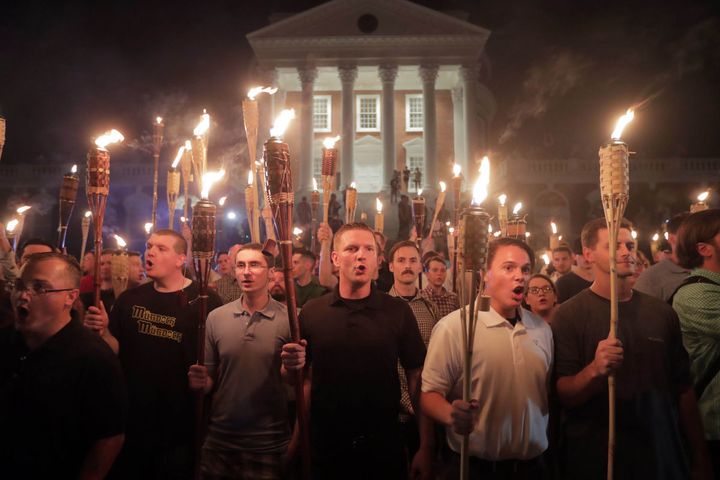 White nationalist ralliers wield torches on University of Virginia campus in Charlottesville.