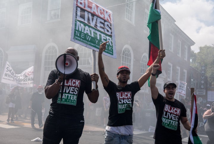 Black Lives Matter protestors stand in a fog of tear gas during clashes at the Unite the Right rally in Charlottesville, Virginia, on Aug. 12, 2017.