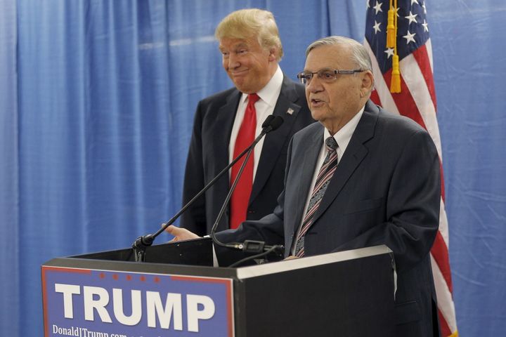 Then-presidential candidate Donald Trump listens to the endorsement of Maricopa County Sheriff Joe Arpaio before a campaign rally in Marshalltown, Iowa, on Jan. 26, 2016.