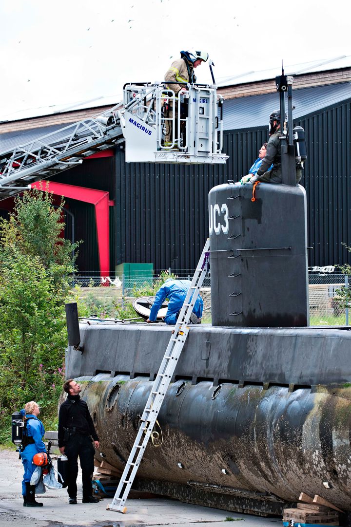 Police technicians investigate the rescued submarine on Aug. 13, 2017.