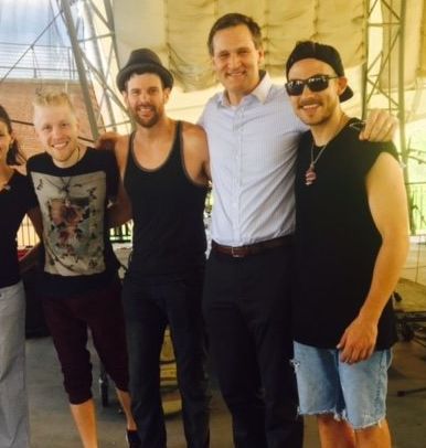 Members of the band Crystal Garden are seen with Charlottesville Mayor Michael Signer, second from right, in July.