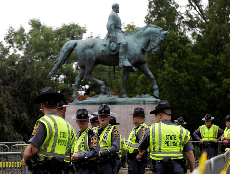 Virginia State Troopers stand under a statue of Robert E. Lee before a white supremacists rally in Charlottesville, Virginia, U.S., August 12, 2017.