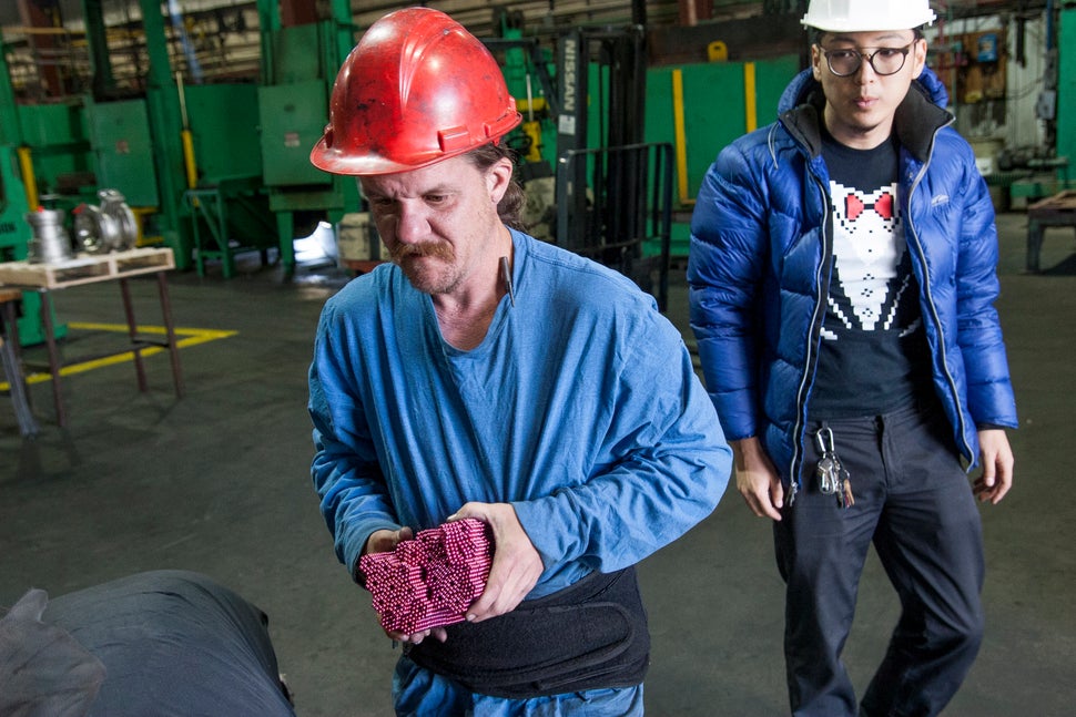 Qu looks on as a worker prepares his super-strong magnets for destruction. 