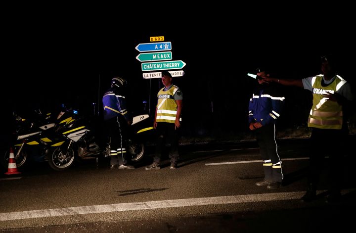 French gendarmes maintain a roadblock a certain distance from the scene where a car ploughed into the outdoor terrace of a pizzeria, killing a young girl and injuring several other people
