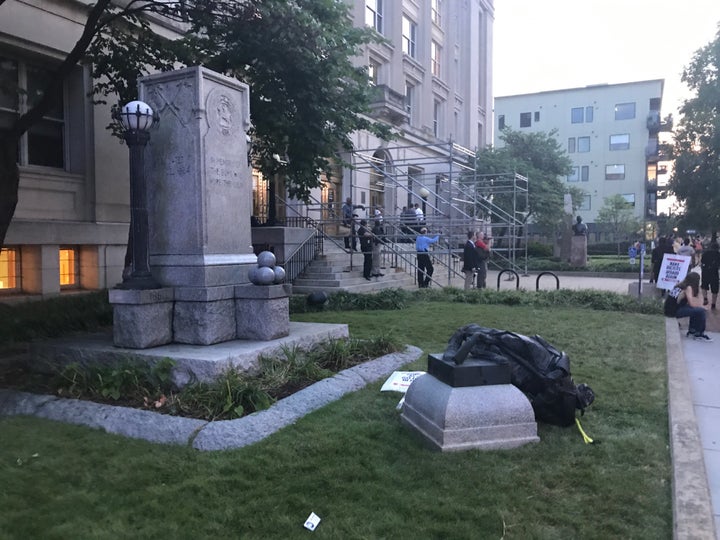 The toppled Confederate monument lies on the grass outside Old Durham County Courthouse.