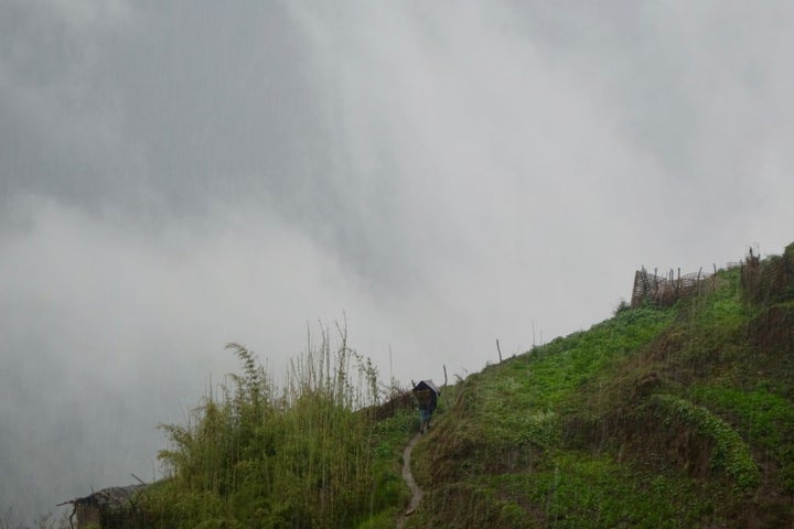 A Nepali villager caught in a hailstorm.