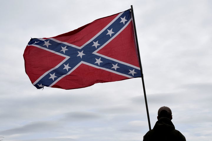 Trevor Jackson displays a Confederate flag during a rally held by Sons of Confederate Veterans in Shawnee, Oklahoma, U.S. March 4, 2017.