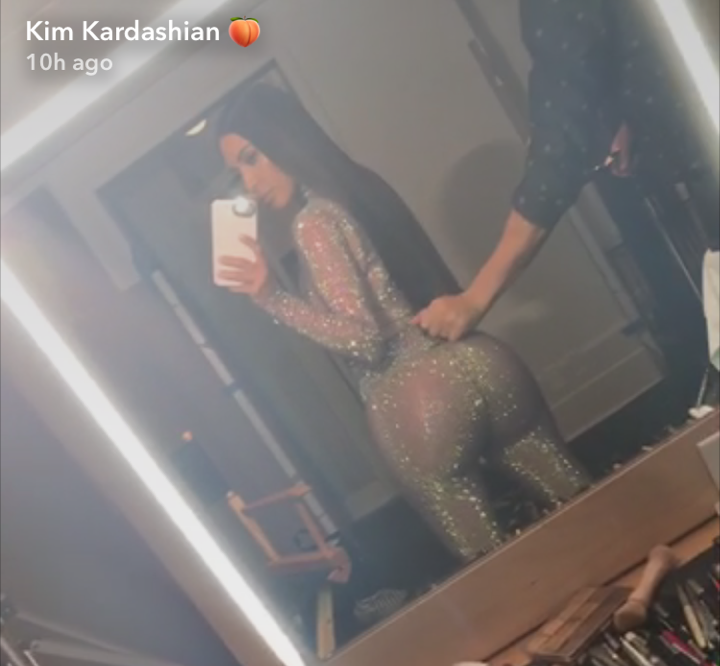 According to her Snapchat videos prior to putting on the glittery ensemble, the reality star wore nude shapewear underneath the bodysuit.