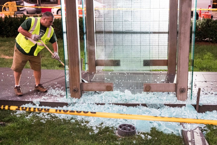 Public Works employees clean up glass shards on the ground from the New England Holocaust Memorial in Boston after it was vandalized on Aug. 14.