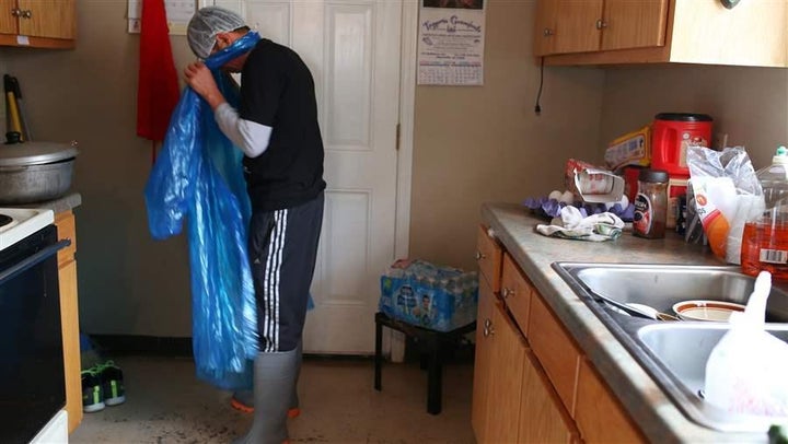 <p>A worker removes the uniform he wears to work in an Alabama chicken plant. In Alabama and other states, a crackdown on illegal workers may be spurring companies to rely more heavily on labor contractors in order to skirt the rules.</p>