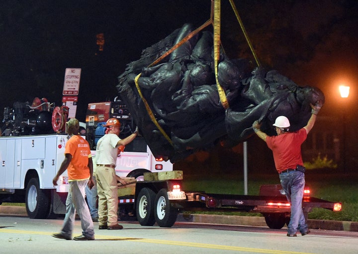 Workers remove a monument dedicated to the Confederate Women of Maryland in Baltimore.