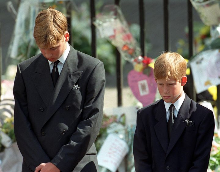 Princes William and Harry bow their heads as their mother's coffin is taken out of Westminster Abbey following her funeral service in 1997
